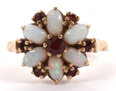 Lot 41 - A 9ct opal and garnet flowerhead ring, the...