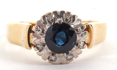 Lot 45 - An 18ct sapphire and diamond ring, the central...