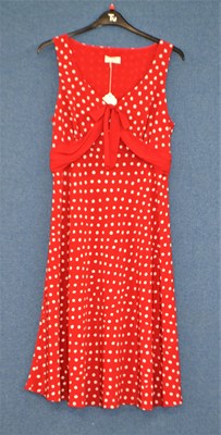 Lot 50 - A red and white polka dot dress together with...