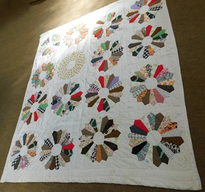 Lot 32 - A patchwork quilt, with cream ground and multi...