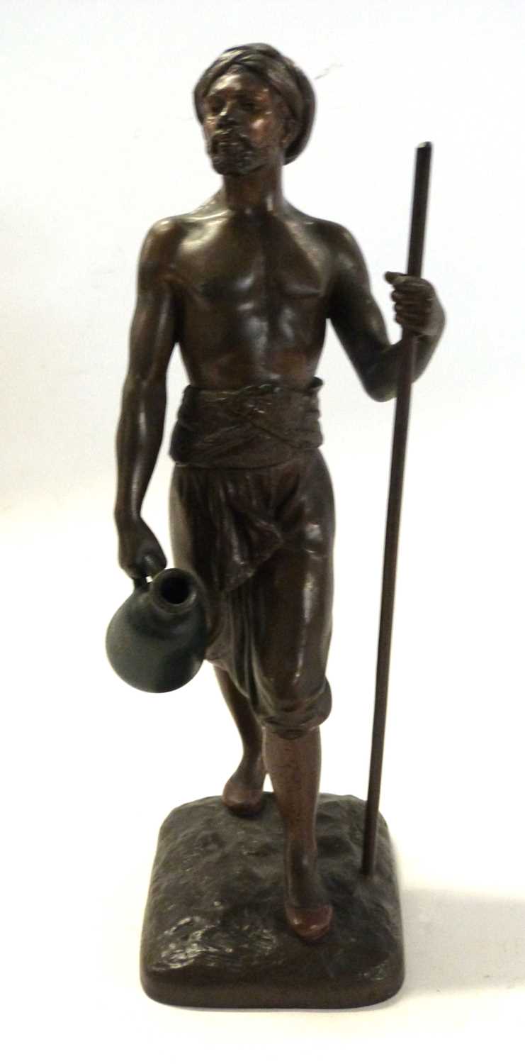 Lot 519 - Spelter model of a tribesman, indistinctly...