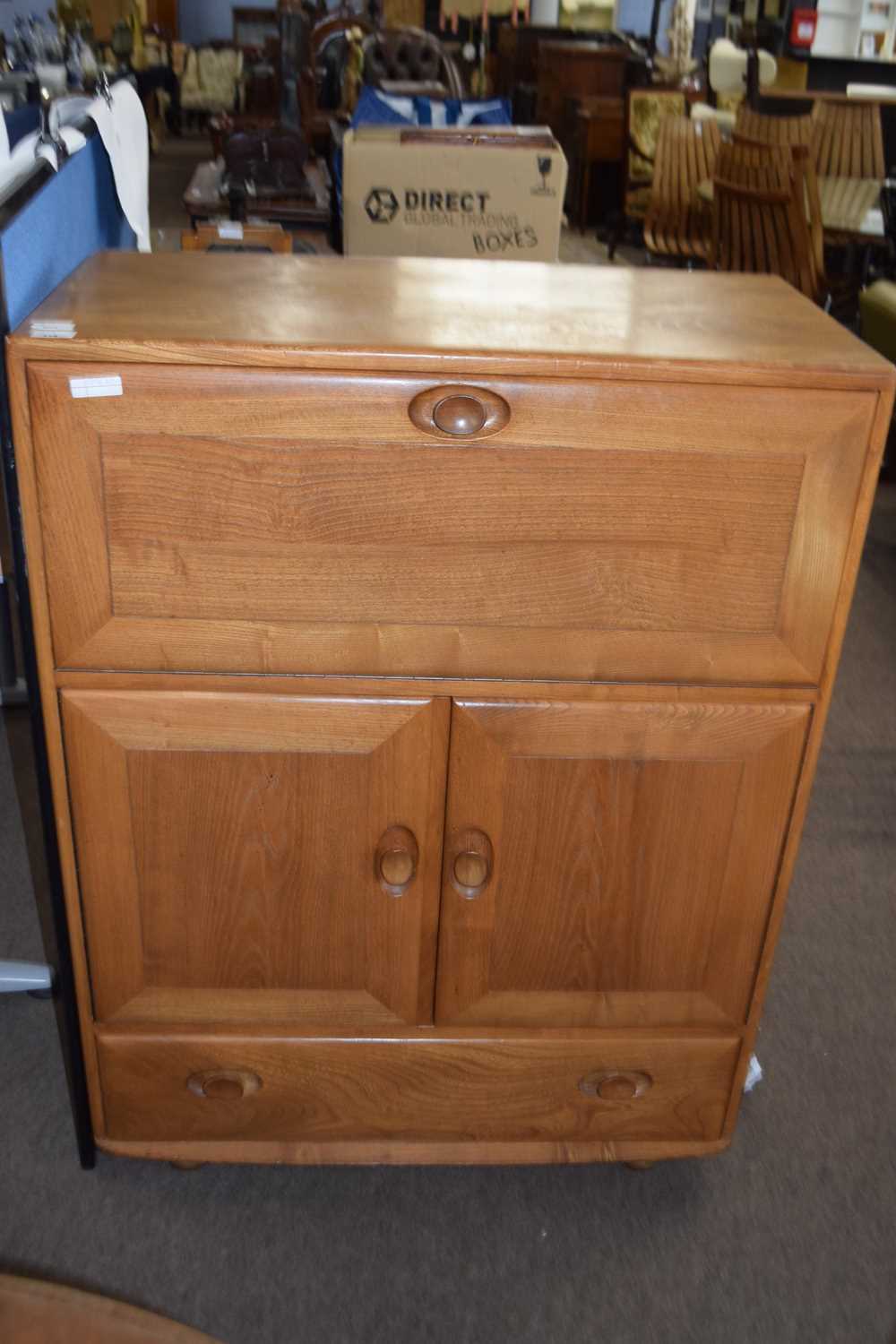 Lot 551 - Ercol light elm drinks cabinet with drop down...