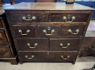 Lot 578 - A Georgian oak chest of drawers with an...