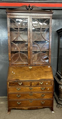 Lot 593 - A Georgian mahogany bureau bookcase cabinet,...