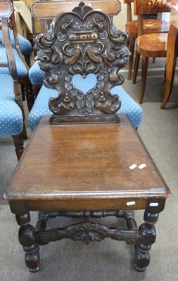 Lot 604 - A 19th Century heavily carved oak hall chair...