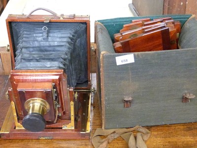 Lot 658 - A hardwood framed bellows camera, the brass...