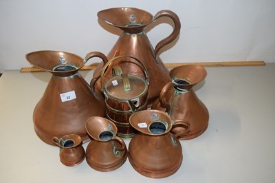 Lot 22 - A graduated set of copper haystack measuring...