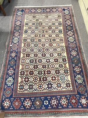 Lot 687 - Persian wool rug with multi star design to...