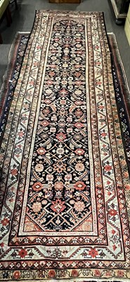 Lot 686 - Persian wool runner carpet with central leaf...