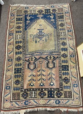 Lot 685 - Middle Eastern wool rug with central mihrab on...