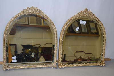 Lot 31 - A pair of small dome topped bevelled mirrors...