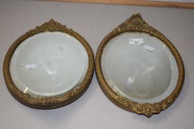 Lot 33 - Pair of oval bevelled wall mirrors in gilt...