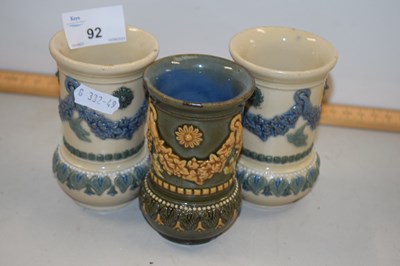 Lot 92 - A group of three small Doulton vases with...