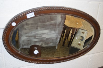 Lot 332 - Early 20th Century oval wall mirror in a dark...