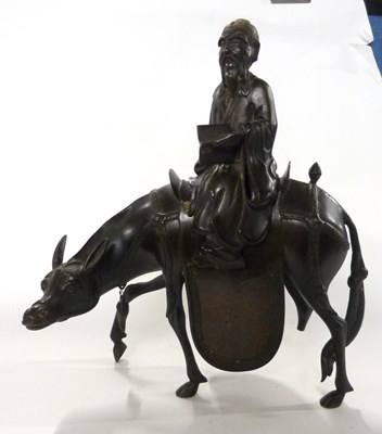 Lot 342 - A Chinese metal figure of an immortal astride...