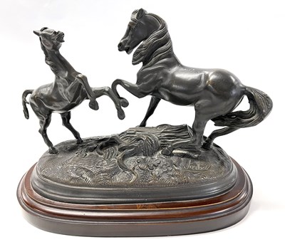 Lot 398 - Pair of Spelter prancing horses on oval metal...