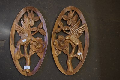 Lot 556 - A pair of carved wooden wall plaques of...