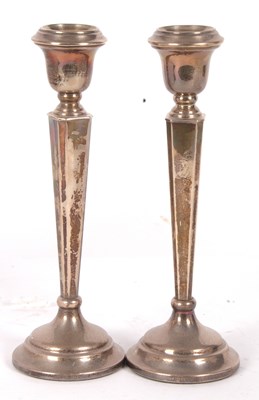 Lot 19 - A pair of silver loaded candlesticks having...