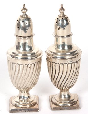 Lot 43 - Pair of Victorian silver peppers of urn shape...