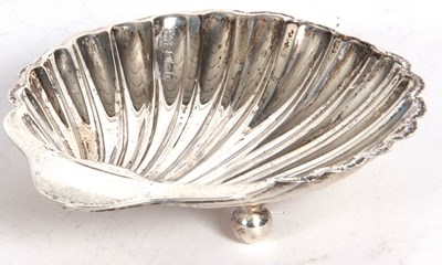 Lot 106 - George V silver shell shaped dish supported on...