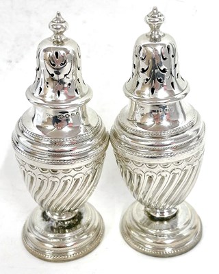 Lot 129 - A pair of Victorian silver peppers, the urn...