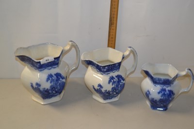 Lot 82 - Three graduated blue and white jugs