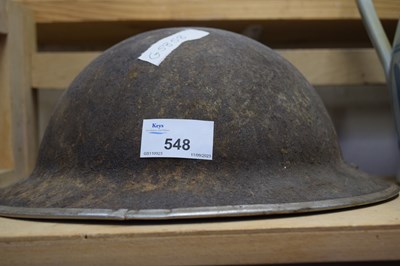 Lot 548 - A vintage military helmet heavily corroded...