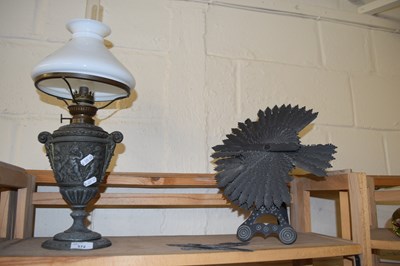 Lot 572 - Oil lamp and a slate garden ornament