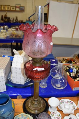 Lot 214 - Victorian oil lamp with cranberry glass font...