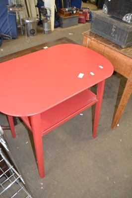 Lot 852 - An oval red side table with single tier below