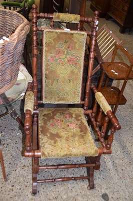 Lot 387 - An American style floral upholstered rocking...