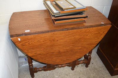 Lot 407 - Early 20th Century oak gate leg dining table