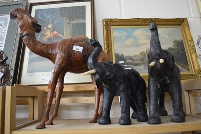 Lot 554 - Leather model of a camel together with two of...