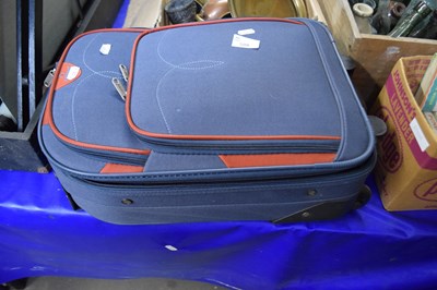 Lot 598 - A carry-on suitcase and a set of four lawn bowls