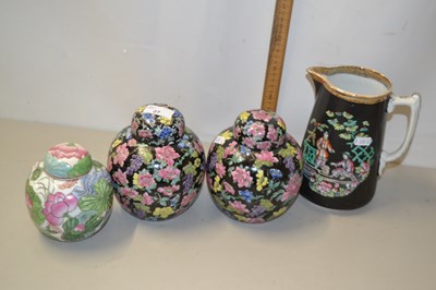 Lot 27 - Two famille noir ginger jars and covers with...