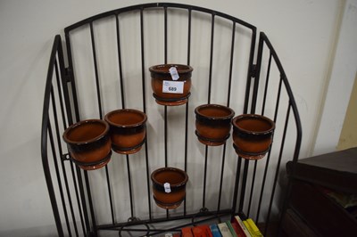 Lot 689 - An metal plant stand and pots