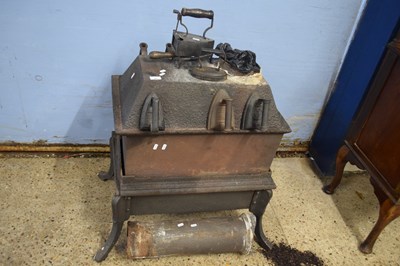 Lot 321 - A vintage cast iron stove together with a...