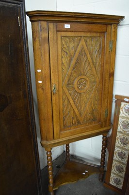 Lot 741 - Pine corner cupboard on stand with carved front