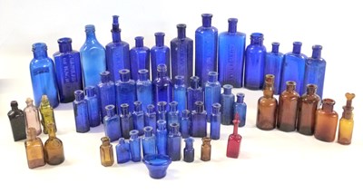 Lot 399 - Quantity of blue and brown glass chemists...