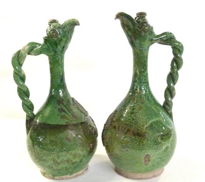 Lot 409 - Pair of pottery green glazed ewers with rope...