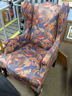 Lot 513 - Georgian style wing back armchair with floral...