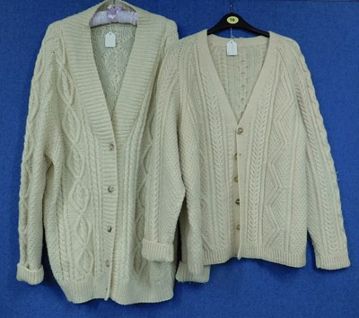 Lot 86 - Two hand knitted cream woollen cardigans, one...