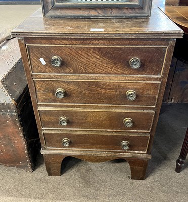 Lot 579 - Small Georgian oak four drawer chest raised on...