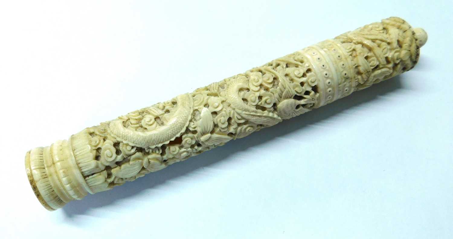 Lot 18 - An Eastern carved bone needle case, the round...