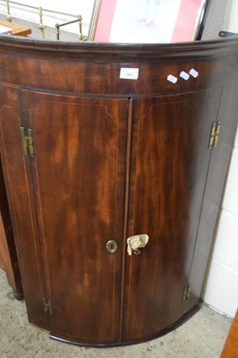 Lot 321 - Georgian mahogany bow front two door corner...