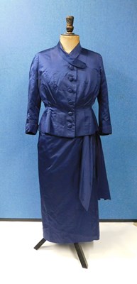 Lot 50 - A navy blue satin dress and matching jacket by...