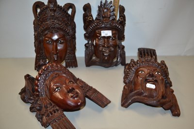 Lot 51 - Two pairs of South East Asian carved wall masks