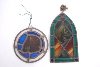 Lot 28 - A stained and leaded glass panel in the form...