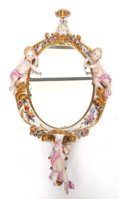 Lot 26 - An oval mirror in continental porcelain frame,...