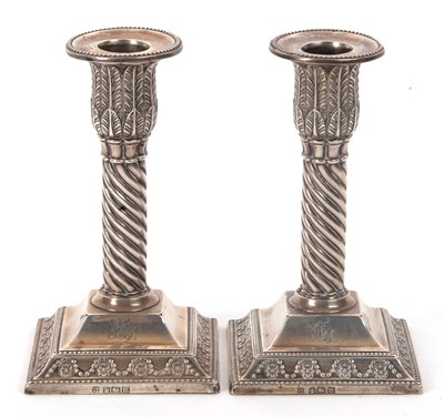 Lot 4 - A pair of Edward VII silver candlestick with...